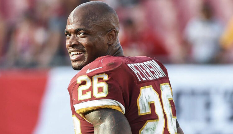 NFL-Player-Adrian-Peterson-smiling-at-the-camera-wearing-a-redskins-uniform.jpg