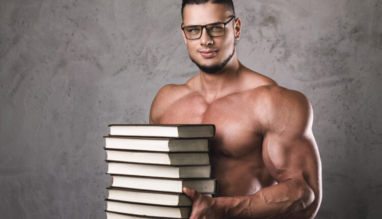 Muscular-Man-Wearing-Glasses-Holding-Stack-of-Books.jpg